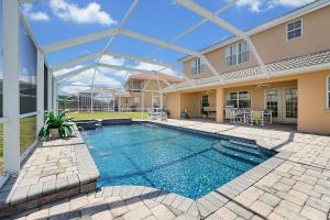 a swimming pool in the backyard of a house at Happy Planet II in Davenport