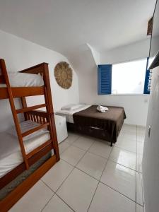 a small room with a bunk bed and a ladder at AZULIKITE in Jericoacoara