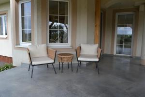two chairs and a table sitting on a porch at Domek mamy in Tykocin +40 photos