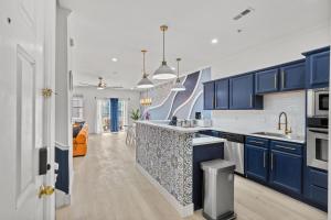 a kitchen with blue cabinets and a counter top at Luxurious Home with Theatre Room in Myrtle Beach