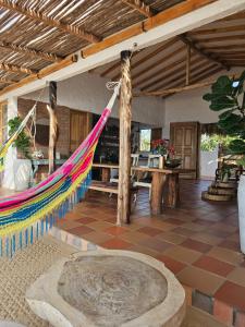 a room with a hammock in a house at El Secreto in Dibulla