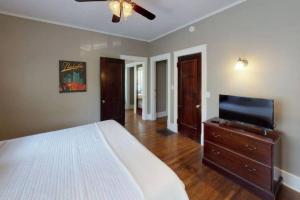 a bedroom with a bed and a flat screen tv at Large Group Downtown Rental - Westend in Nashville