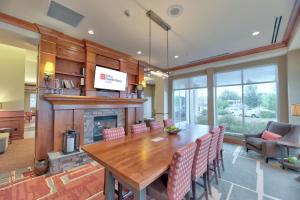 a dining room with a table and a fireplace at Hilton Garden Inn Laramie in Laramie