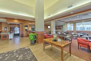 a lobby of a hotel with tables and chairs at Hilton Garden Inn Laramie in Laramie