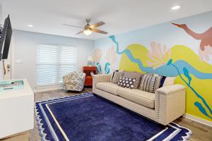 a living room with a couch and a painting on the wall at Sand Dollar #14 in Gulf Shores