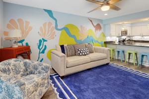 a living room with a couch and a kitchen at Sand Dollar #14 in Gulf Shores