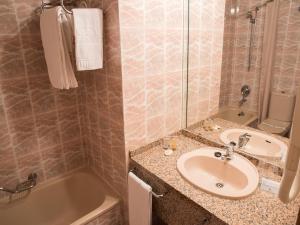 a bathroom with a sink and a bath tub at AR Roca Esmeralda & SPA Hotel in Calpe