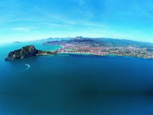 an island in the middle of a large body of water at AR Roca Esmeralda & SPA Hotel in Calpe