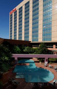 a hotel with a swimming pool in front of a building at DoubleTree by Hilton San Antonio Airport in San Antonio