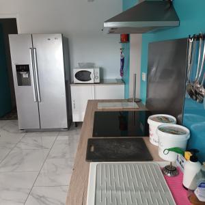 eine Küche mit einem Kühlschrank und einer Arbeitsplatte in der Unterkunft La petite maison Lavandin 