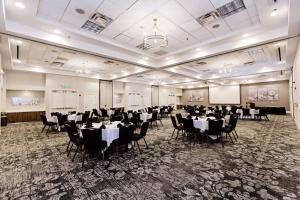 a banquet hall with tables and chairs in a room at Hilton Garden Inn Temple Medical Center in Temple