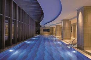 a hallway with a blue floor in a building at DoubleTree by Hilton Hotel Xiamen - Wuyuan Bay in Xiamen