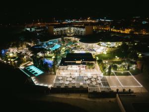 an aerial view of a building with lights at night at UNAHOTELS MH Matera in Matera
