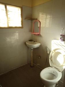 a small bathroom with a toilet and a sink at Bangalore homestay in Bangalore
