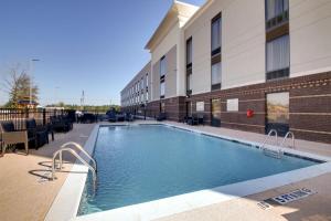 a large swimming pool in front of a building at Hampton Inn & Suites Cordele in Cordele
