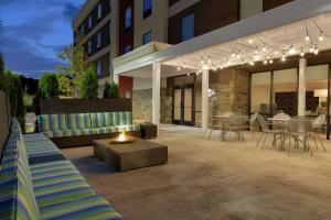 a patio with a fire pit and a building at Home2 Suites by Hilton Cartersville in Cartersville