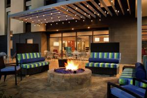 a fire pit in a lobby with chairs and a table at Home2 Suites By Hilton Macon I-75 North in Macon