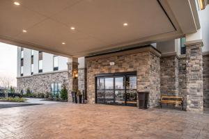 a lobby of a building with a door and a bench at Hampton Inn - Paragould in Paragould