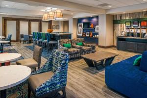 a lobby with couches and tables and a bar at Hampton Inn - Paragould in Paragould