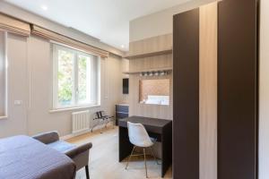 a bedroom with a desk and a bed and a desk at Casa Ilaria in Naples