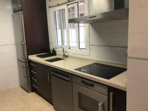 a kitchen with a sink and a stove at Casa tranquila in Teulada