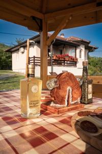 a bottle of whiskey sitting on a picnic table at Zlatni Prag - Kraljevo in Kraljevo