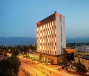 a tall building with a sign on the side of it at Hampton By Hilton Bolu in Bolu