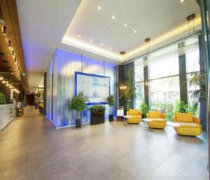 a lobby with couches and plants in a building at Hampton By Hilton Bolu in Bolu