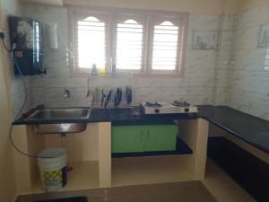 a kitchen with a sink and a counter top at Bangalore homestay in Bangalore