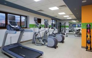 a gym with several treadmills and elliptical machines at Hampton By Hilton Astana Triumphal Arch in Astana