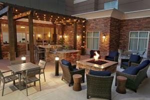 a patio with chairs and tables and a fire pit at Homewood Suites By Hilton West Fargo/Sanford Medical Center in Fargo