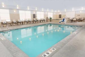 a large pool with blue water in a building at Homewood Suites By Hilton West Fargo/Sanford Medical Center in Fargo