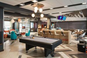 a billiard room with a pool table and a bar at Tru By Hilton Cedar Rapids Westdale in Cedar Rapids