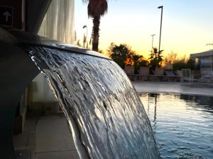 a water fountain in front of a swimming pool at Yes Hotel Touring & SPA in Rimini