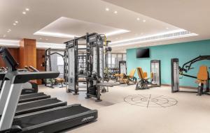 a gym with treadmills and machines in a room at DoubleTree by Hilton Dubai Al Jadaf in Dubai