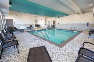 a large swimming pool with chairs around it at Hampton Inn Mustang in Mustang