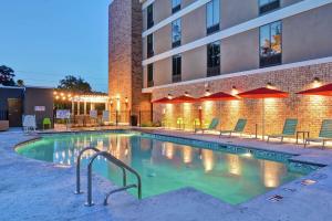 a swimming pool in front of a building at Home2 Suites By Hilton Beaufort in Beaufort
