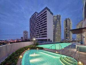 a swimming pool on the roof of a building at Hilton Garden Inn Sanya in Sanya
