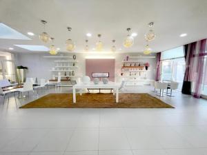 a living room with white furniture and a table and chairs at Yes Hotel Touring & SPA in Rimini