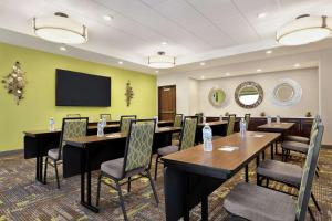 a conference room with tables and chairs and a flat screen tv at Hampton Inn West Valley Salt Lake City in West Valley City