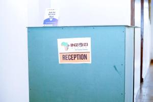 a blue locker with a sign on it at INZOZI AFRICA HOUSE B&B-Kimihurura in Kigali
