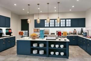 a large kitchen with blue cabinets and a counter at Homewood Suites By Hilton Horsham Willow Grove in Horsham