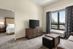 a hotel room with a bed and a flat screen tv at Homewood Suites By Hilton Horsham Willow Grove in Horsham