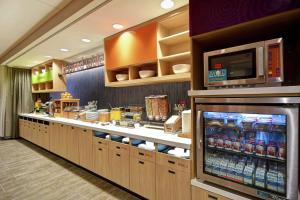 a kitchen with a counter with a microwave at Home2 Suites By Hilton Shreveport in Shreveport
