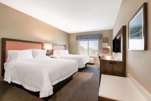 a hotel room with two beds and a television at Hampton Inn Batesville, Ar in Batesville +21 photos