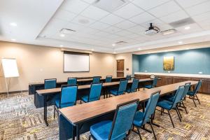 a conference room with tables and chairs and a screen at Hampton Inn Batesville, Ar in Batesville