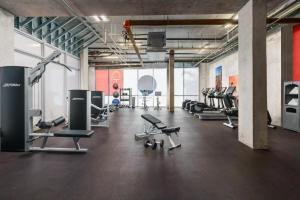 a gym with several treadmills and chairs in it at New! Beach Access with Rooftop Pool in Hollywood