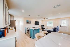 a kitchen and living room with a couch and a table at Just for Sun in Jacksonville