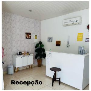 a kitchen with a counter and a stool in a room at Hostel das Flores in Belém