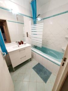 uma casa de banho com um chuveiro, um lavatório e uma banheira em Appart 70m² plein sud em Marignane